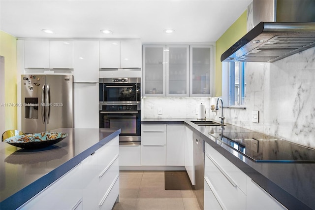 kitchen with ventilation hood, sink, white cabinets, light tile patterned floors, and stainless steel appliances