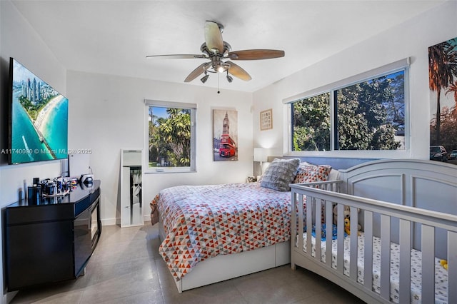 bedroom with multiple windows and ceiling fan