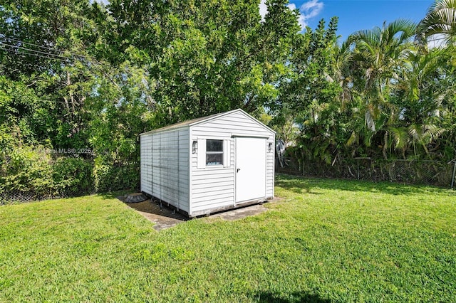 view of outbuilding with a lawn