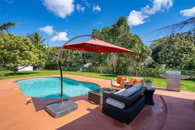 view of pool with a patio, a yard, and area for grilling