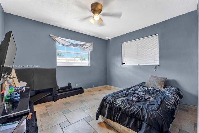 bedroom with a textured ceiling and ceiling fan