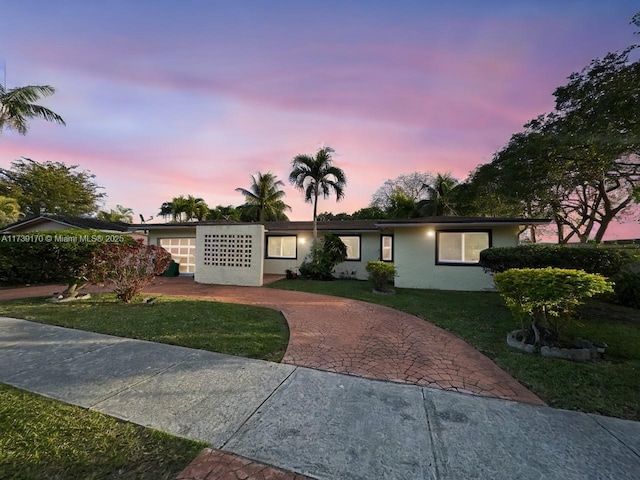 single story home featuring a yard