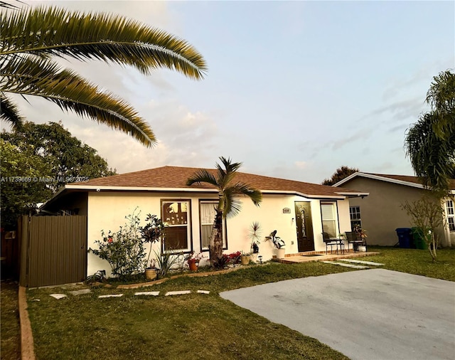 rear view of property with a patio and a lawn