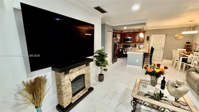 living room featuring ornamental molding and a stone fireplace