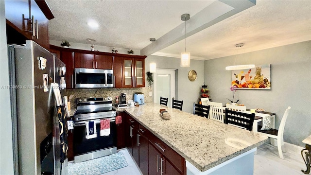 kitchen with pendant lighting, appliances with stainless steel finishes, light stone countertops, a textured ceiling, and kitchen peninsula