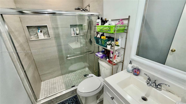 bathroom featuring walk in shower, vanity, and toilet