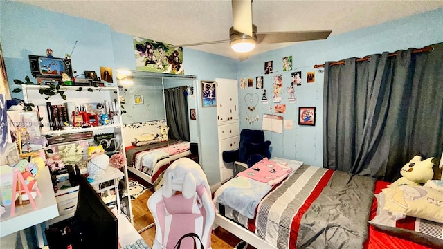 bedroom featuring hardwood / wood-style flooring, a closet, and ceiling fan