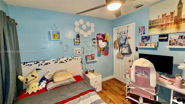 bedroom featuring hardwood / wood-style flooring and ceiling fan