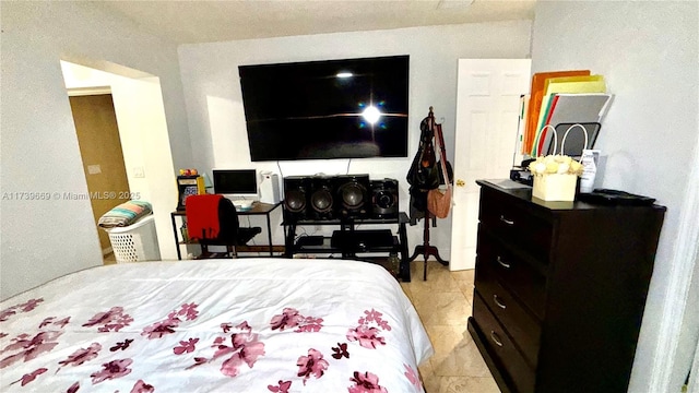 bedroom with light tile patterned floors