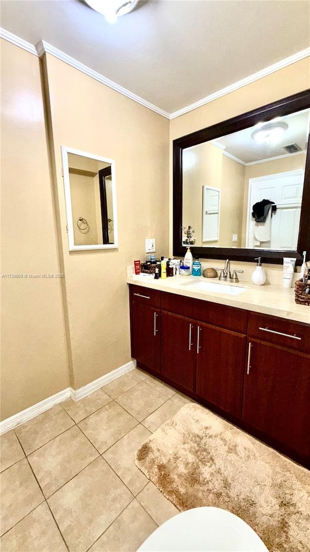 bathroom featuring vanity, tile patterned flooring, and ornamental molding