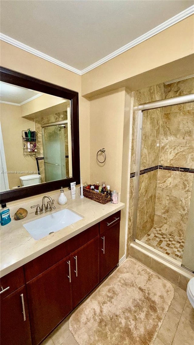 bathroom featuring ornamental molding, vanity, walk in shower, toilet, and tile patterned floors