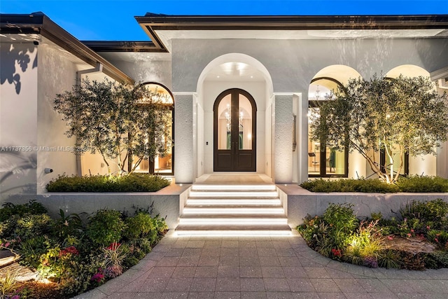 property entrance with french doors and stucco siding