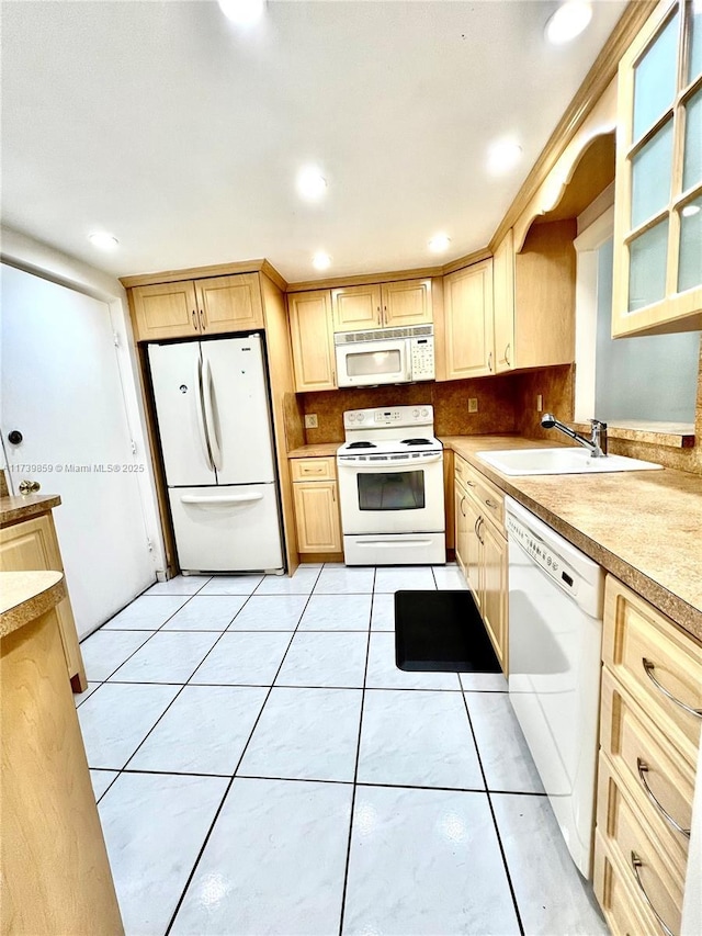 kitchen featuring white appliances, light brown cabinetry, sink, and light tile patterned floors