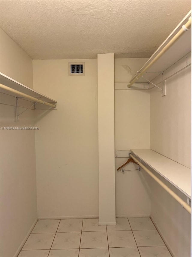 spacious closet featuring light tile patterned floors