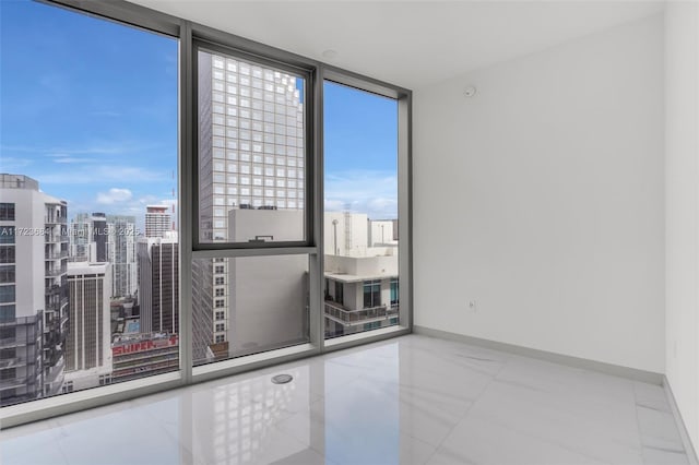 spare room with expansive windows and plenty of natural light