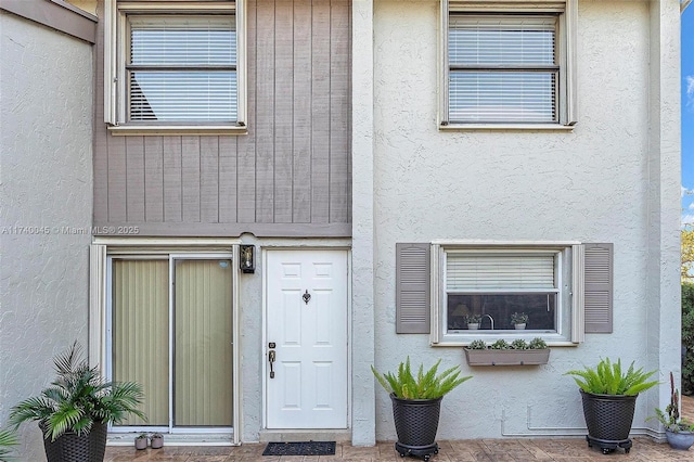 property entrance featuring stucco siding