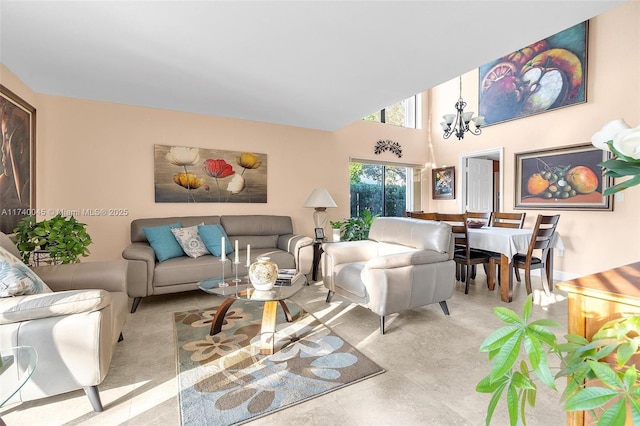 living room featuring a chandelier and a towering ceiling