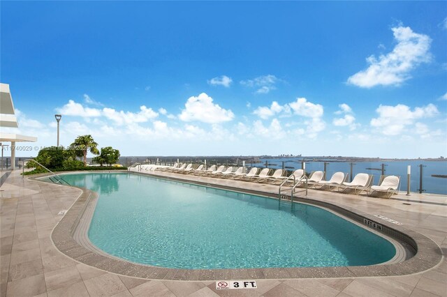 view of pool featuring a water view