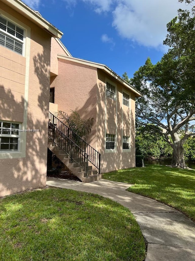 view of side of property with a lawn