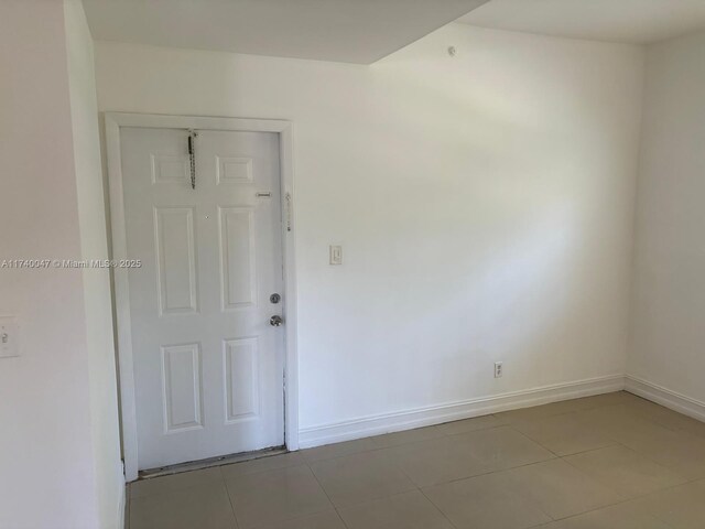 620 Cypress Club Way Unit I13, Deerfield Beach, FL 33064 - unfurnished room featuring baseboards and light tile patterned floors