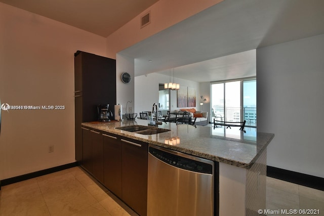 kitchen with light tile patterned flooring, sink, stainless steel dishwasher, kitchen peninsula, and light stone countertops