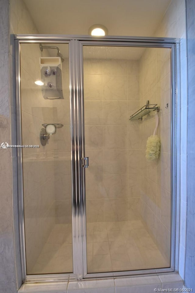 bathroom with a shower with shower door