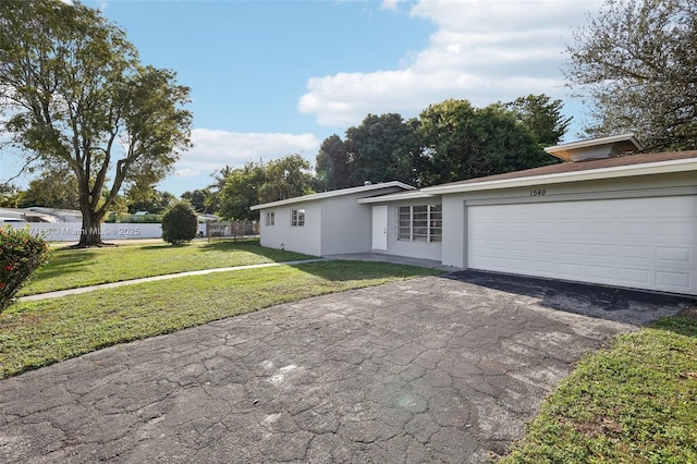 view of front facade featuring a garage and a front lawn