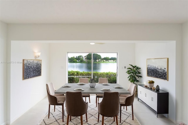 tiled dining space with a water view