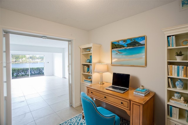 tiled home office with a textured ceiling