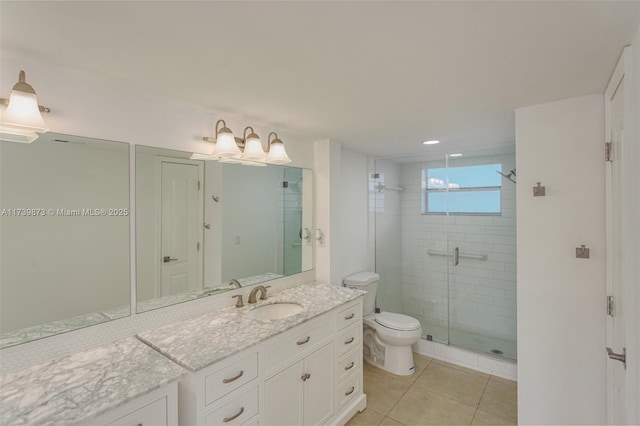 bathroom with tile patterned floors, toilet, a shower with door, and vanity