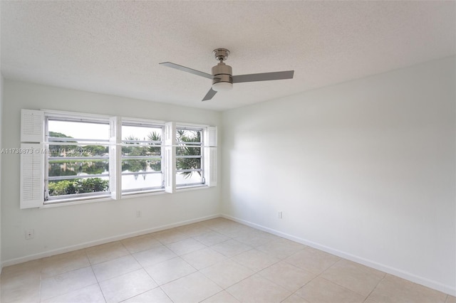 unfurnished room featuring ceiling fan and a textured ceiling