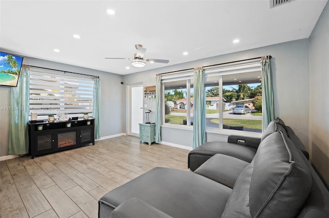 living room featuring ceiling fan and light wood-type flooring