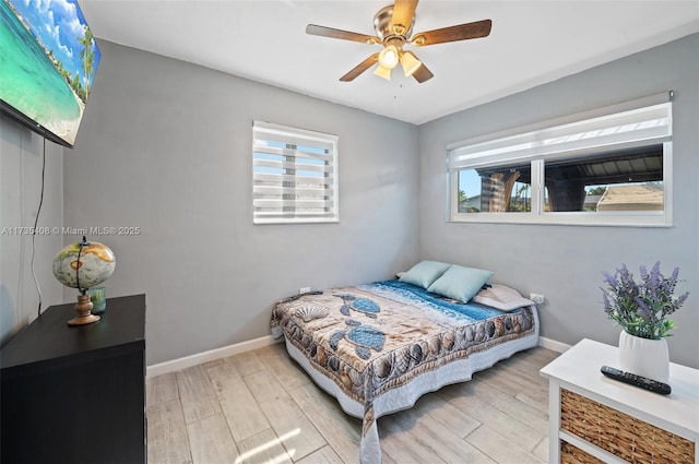 bedroom with ceiling fan and light hardwood / wood-style floors