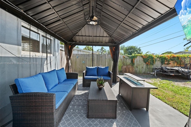 view of patio with a gazebo and an outdoor living space with a fire pit