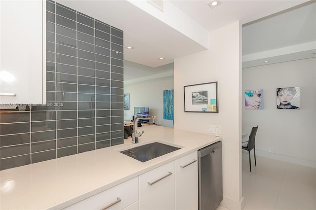 kitchen featuring white cabinetry, sink, tile patterned floors, and dishwasher