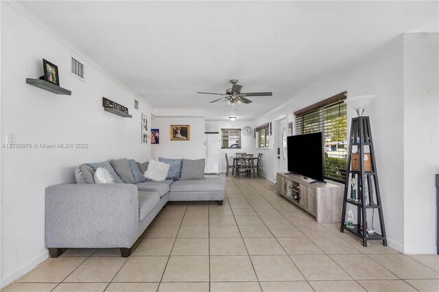 tiled living room featuring crown molding and ceiling fan