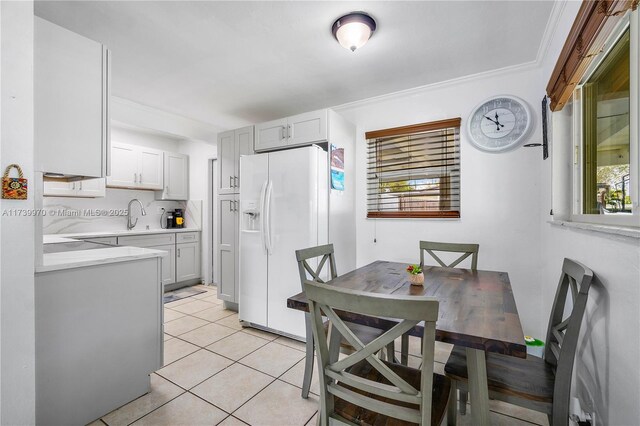 tiled dining area with ornamental molding and sink