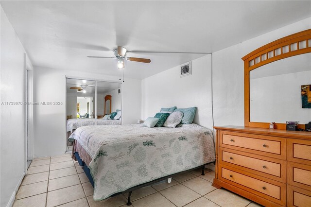 tiled bedroom with ceiling fan