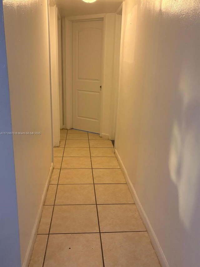 hall with light tile patterned floors