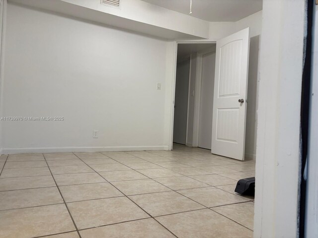 spare room featuring light tile patterned floors