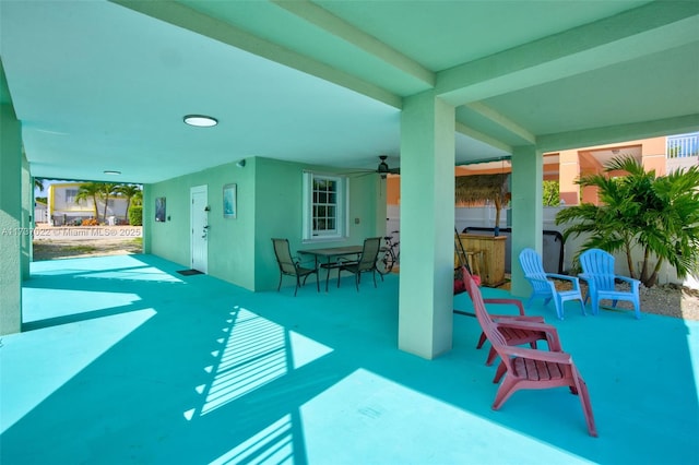 view of patio featuring ceiling fan and a bar