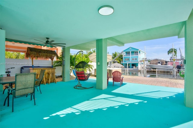 view of patio with a bar and ceiling fan