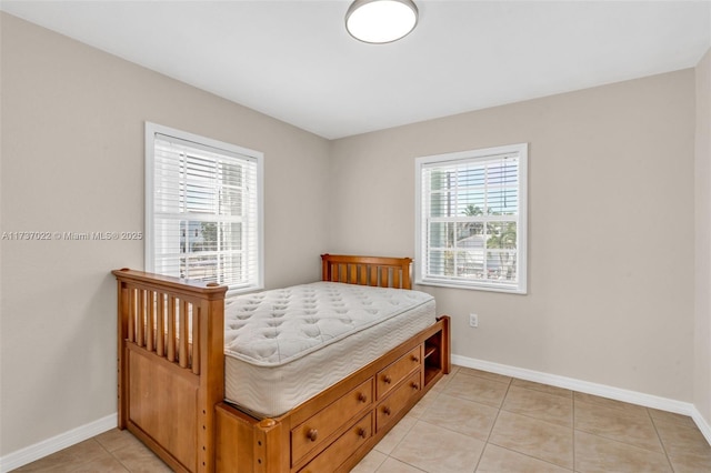 bedroom with light tile patterned flooring and multiple windows