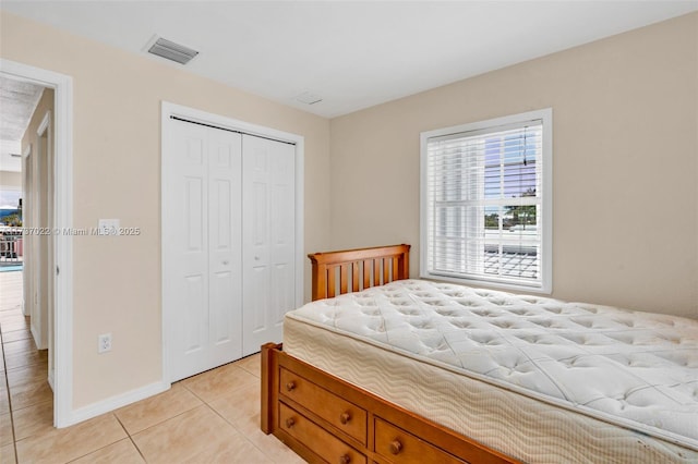 tiled bedroom with a closet