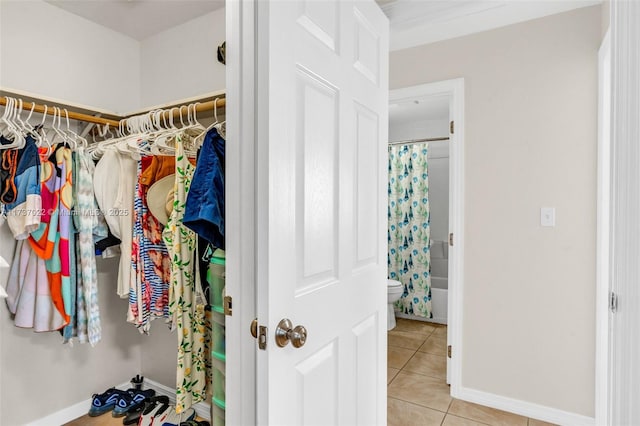 spacious closet featuring light tile patterned floors