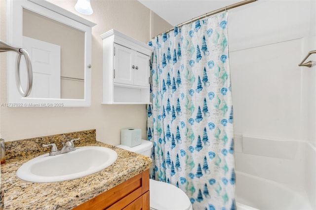 full bathroom with vanity, shower / bath combo, and toilet