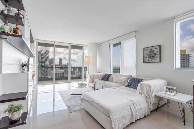 living room featuring floor to ceiling windows and light tile patterned floors