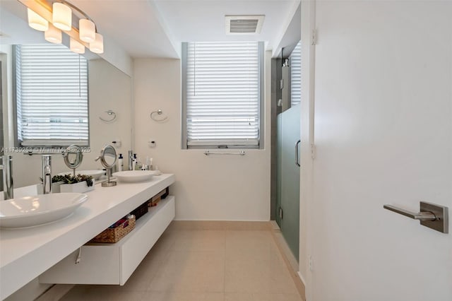 bathroom featuring tile patterned flooring, an enclosed shower, and vanity