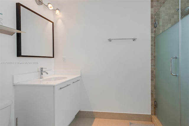 bathroom featuring tile patterned floors, vanity, toilet, and an enclosed shower