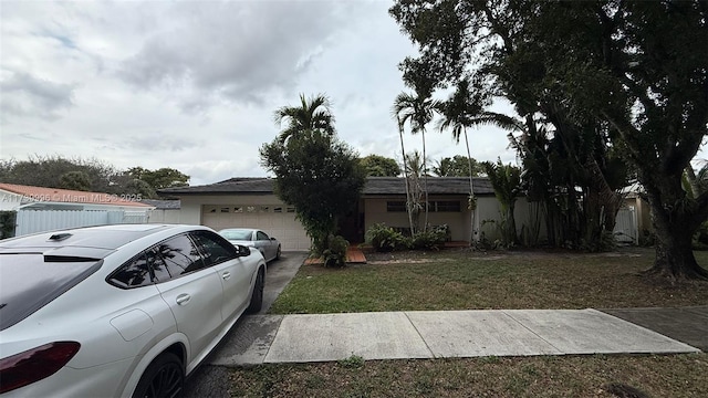 ranch-style home with a front yard and an attached garage